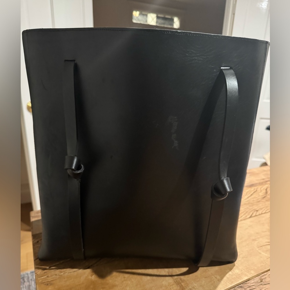 Janessa Leone leather weekender bag with hat carrying straps